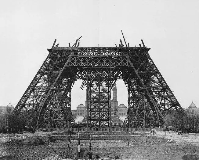 the first level of the Eiffel Tower completed in March 1888, with the legs joined together