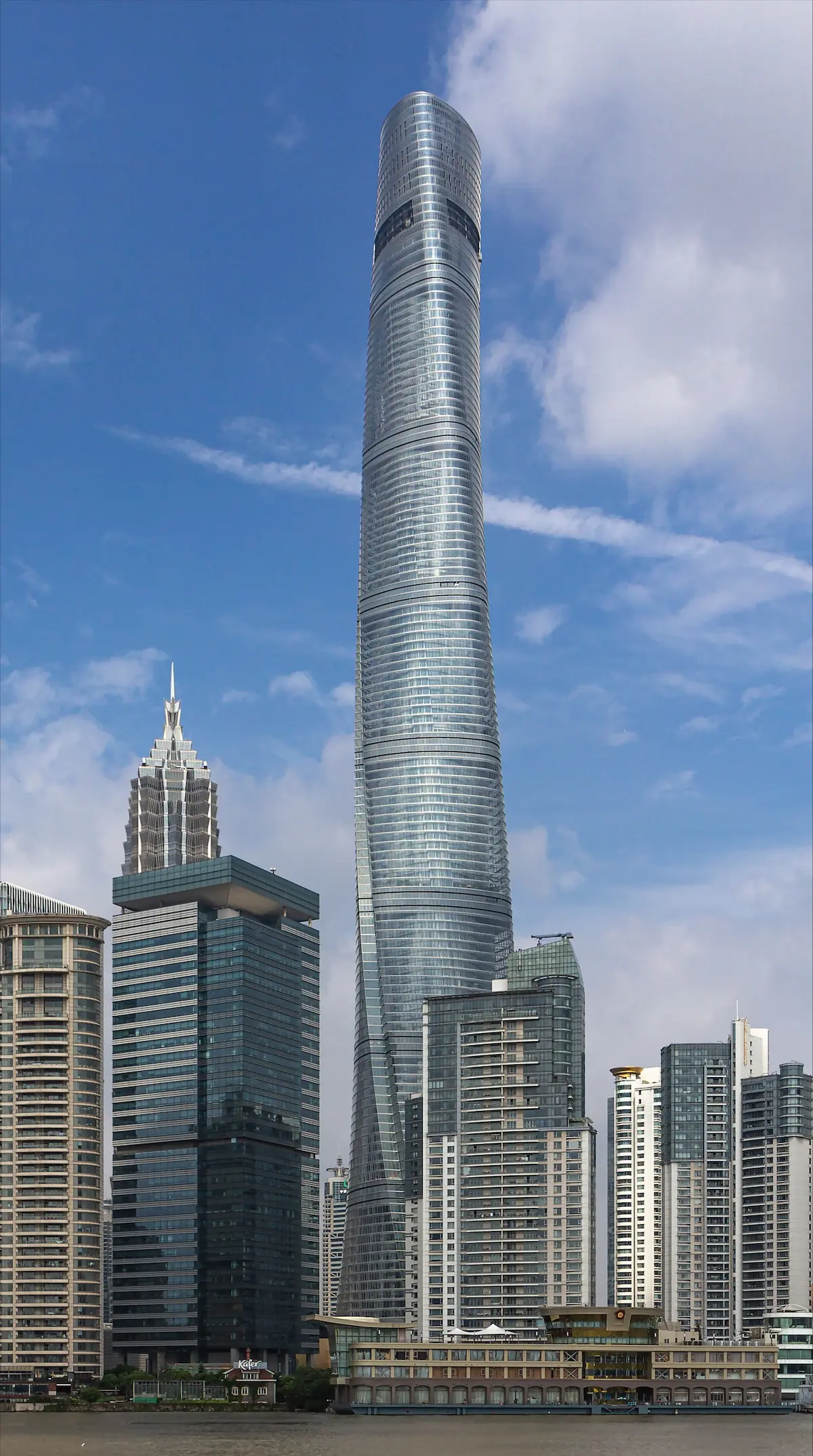 Full view of the Shanghai Tower, highlighting its towering presence and spiral design against the city skyline.