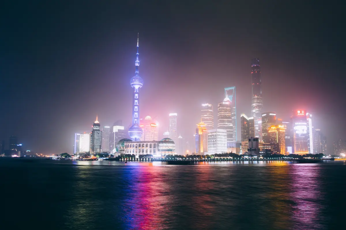 Shanghai skyline featuring modern skyscrapers, including the iconic Oriental Pearl Tower and the Shanghai Tower.