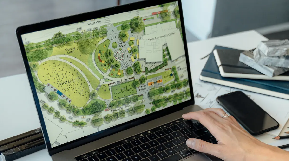 An architect studying site analysis data on a computer screen.