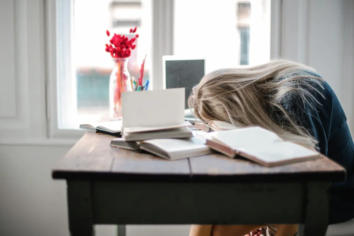 architecture student with head buried in her desk, indicating a moment of struggle