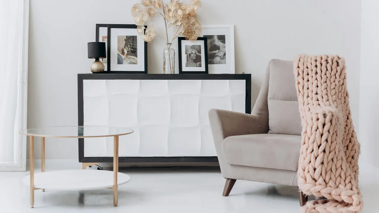 minimalist interior design featuring a beige sofa chair near a table