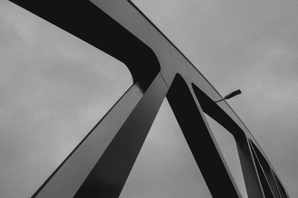 A bridge beams in black and white.
