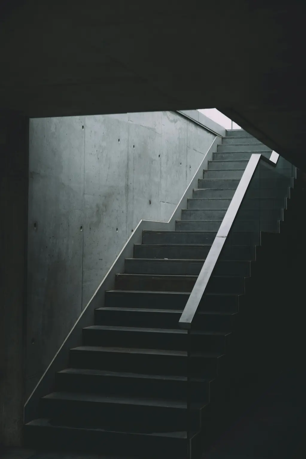 A staircase bathed in natural light from above, creating a bright and airy atmosphere.