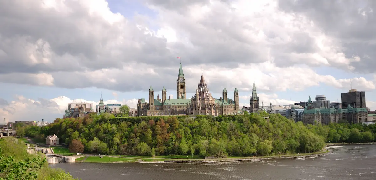 Wide-angle view of the Canadian Parliament Buildings, showcasing the Gothic Revival architecture.