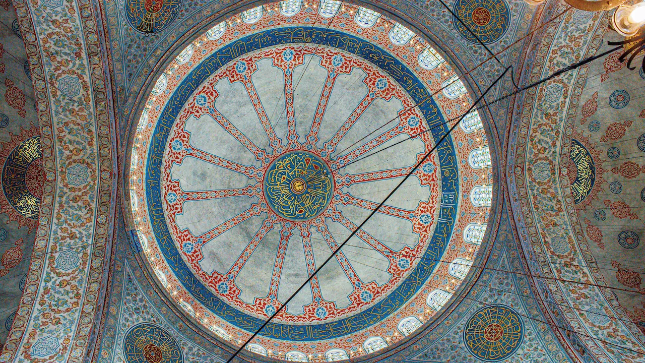 View of the ceiling in the Blue Mosque in Istanbul, Turkey, showcasing intricate patterns and stunning architectural details.