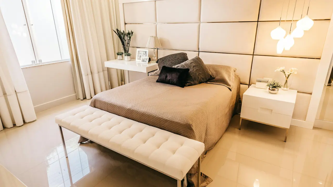 Cozy modern bedroom with a one-tone light creamy color scheme, creating a warm and relaxing atmosphere.
