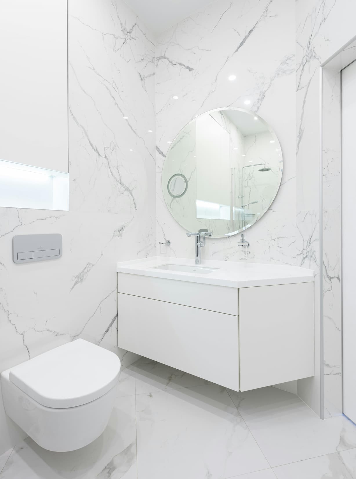 All-white bathroom with a seamless color-drenching design, creating a clean and modern look.
