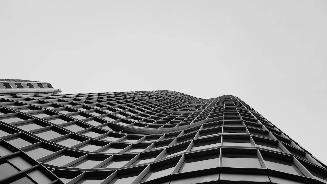 A modern curved building facade in Vancouver, Canada, featuring innovative materials and a striking black-and-white design.