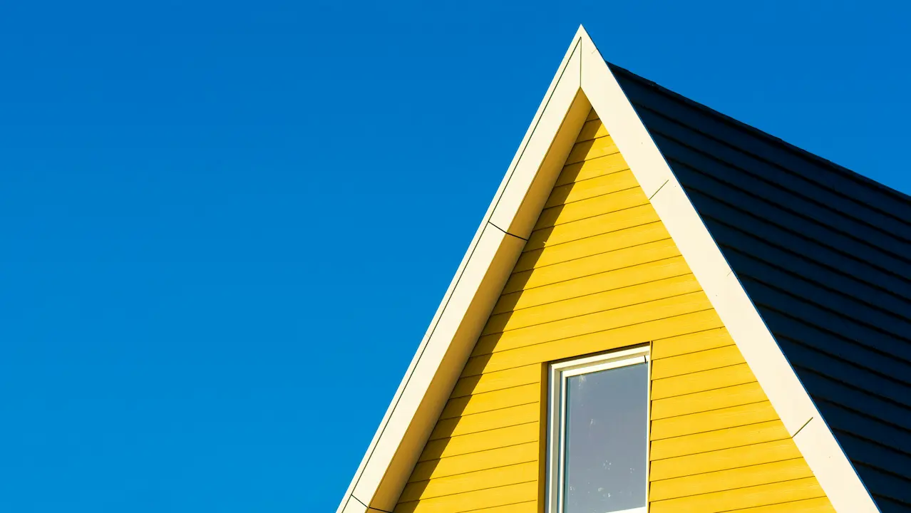 Distinctive roof design with a mix of yellow and dark grey colors.