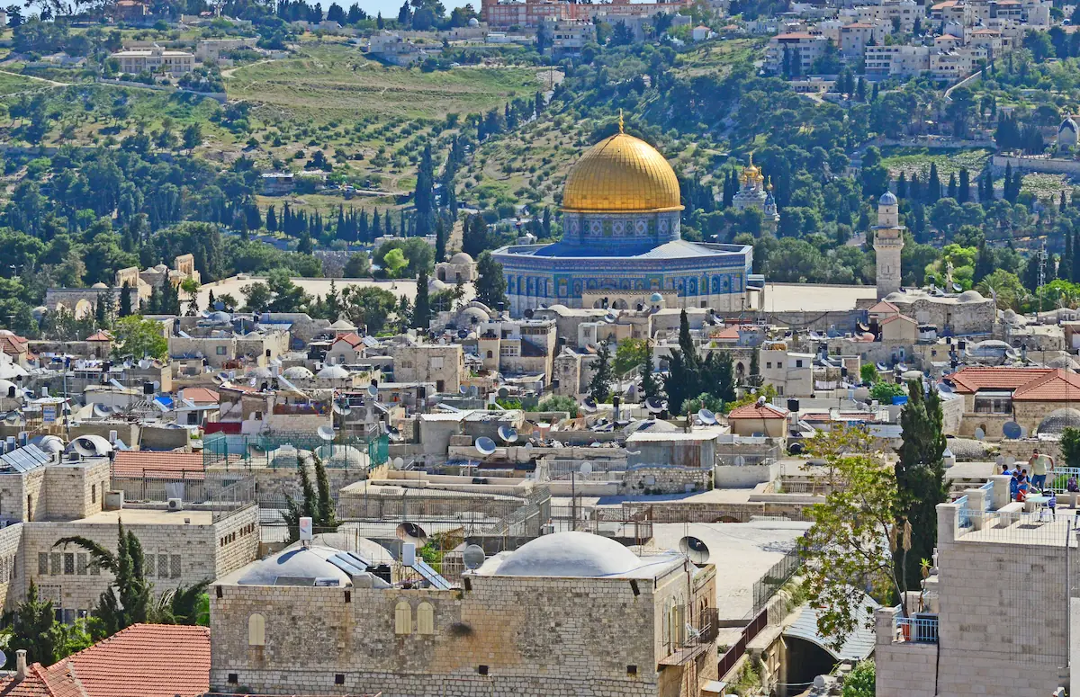 Dome of the Rock in Jerusalem, showcasing its golden dome, intricate Islamic geometric patterns, and surrounding courtyards.
