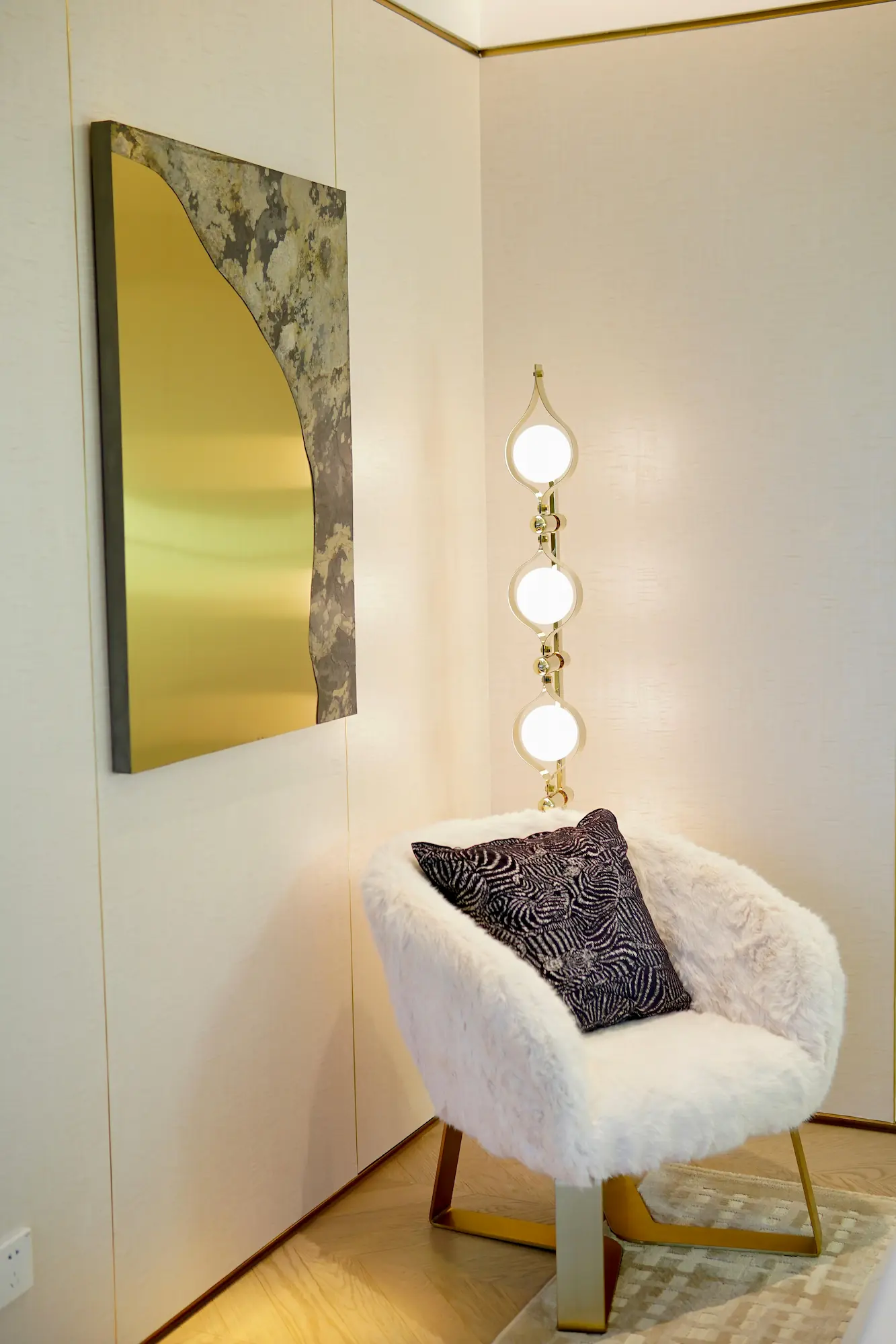 large painting serving as the focal point above an armchair in a minimalist corner setup