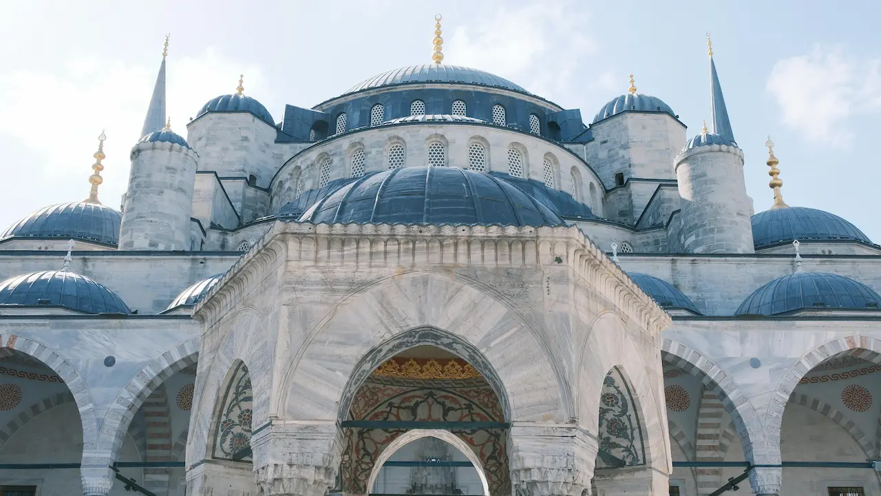 Front view of the iconic Blue Mosque in Istanbul, Turkey, highlighting its grand entrance and intricate architectural details.