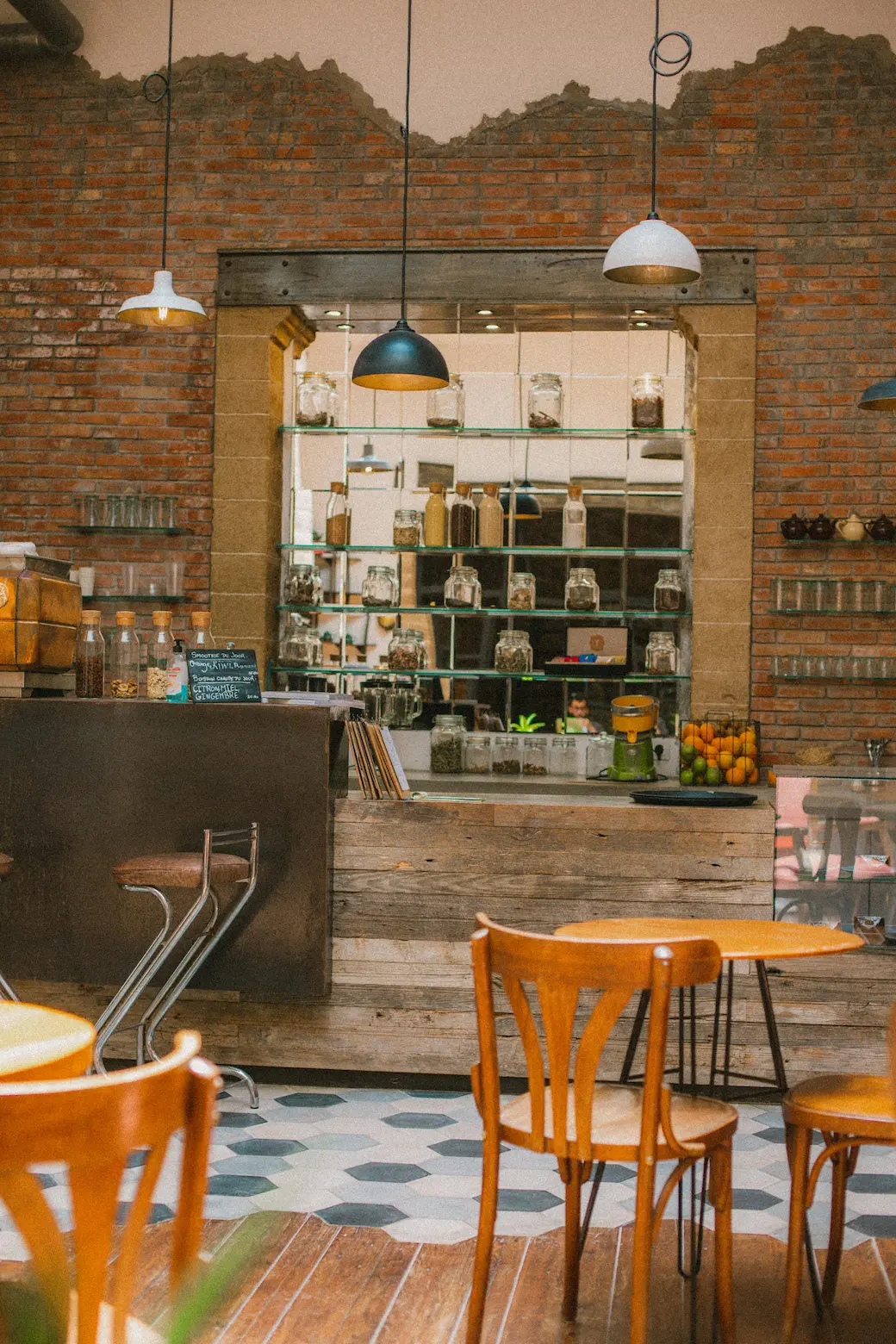 Industrial kitchen with table and chairs in a cafe setting.