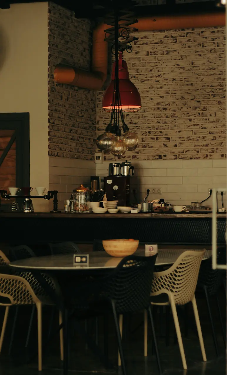 Industrial kitchen with table and chairs.