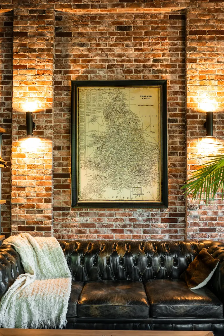 Industrial-style living room with brown wooden-framed wall decor.