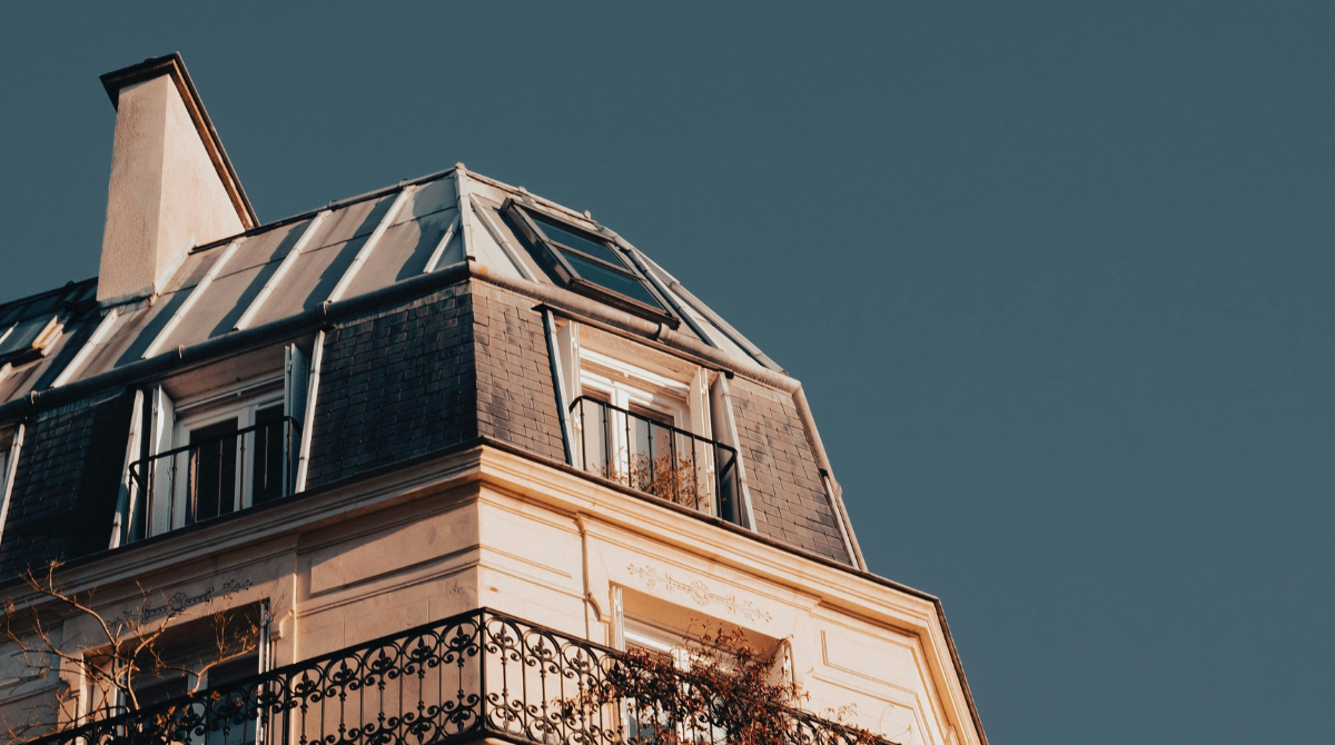 Mansard roof line on a building in Paris, France, with a distinct dual-pitch design