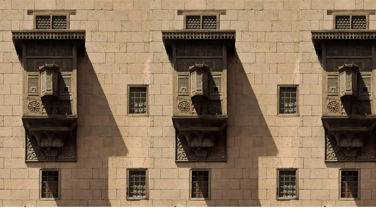 traditional mashrabiya wooden screen on historic building in islamic cairo, showcasing intricate craftsmanship