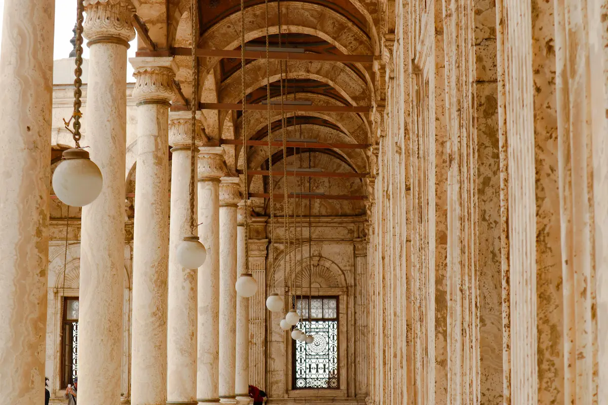 A hallway in Cairo, Egypt, showcasing medieval Islamic architecture with intricate arches and decorative details.