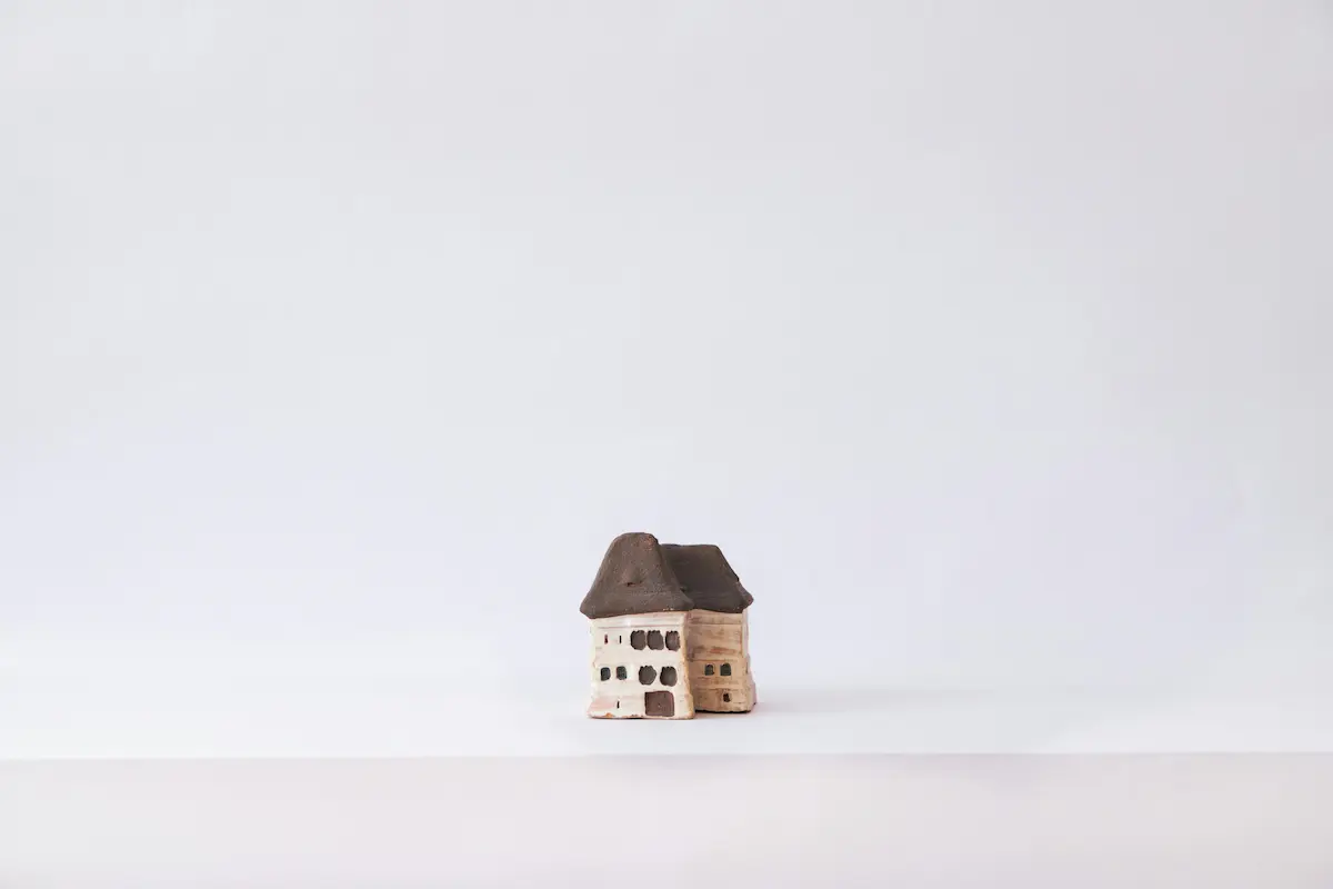 A detailed miniature house model showcasing architectural features in a compact form.
