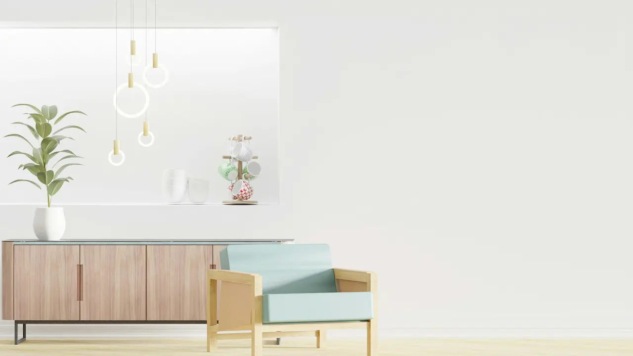 minimalist interior with an armchair placed near a lamp and dresser, creating a cozy and modern vibe