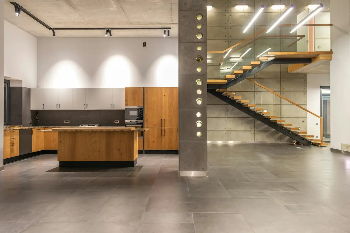 A sleek modern apartment featuring minimalist design with concrete walls and steel accents, creating an industrial charm.