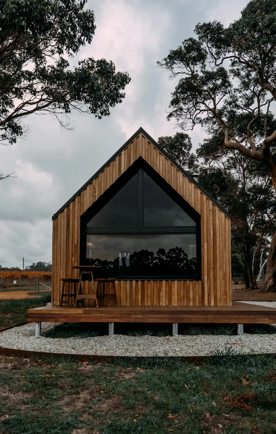 A modern countryside cabin with sleek design elements nestled in a natural setting.