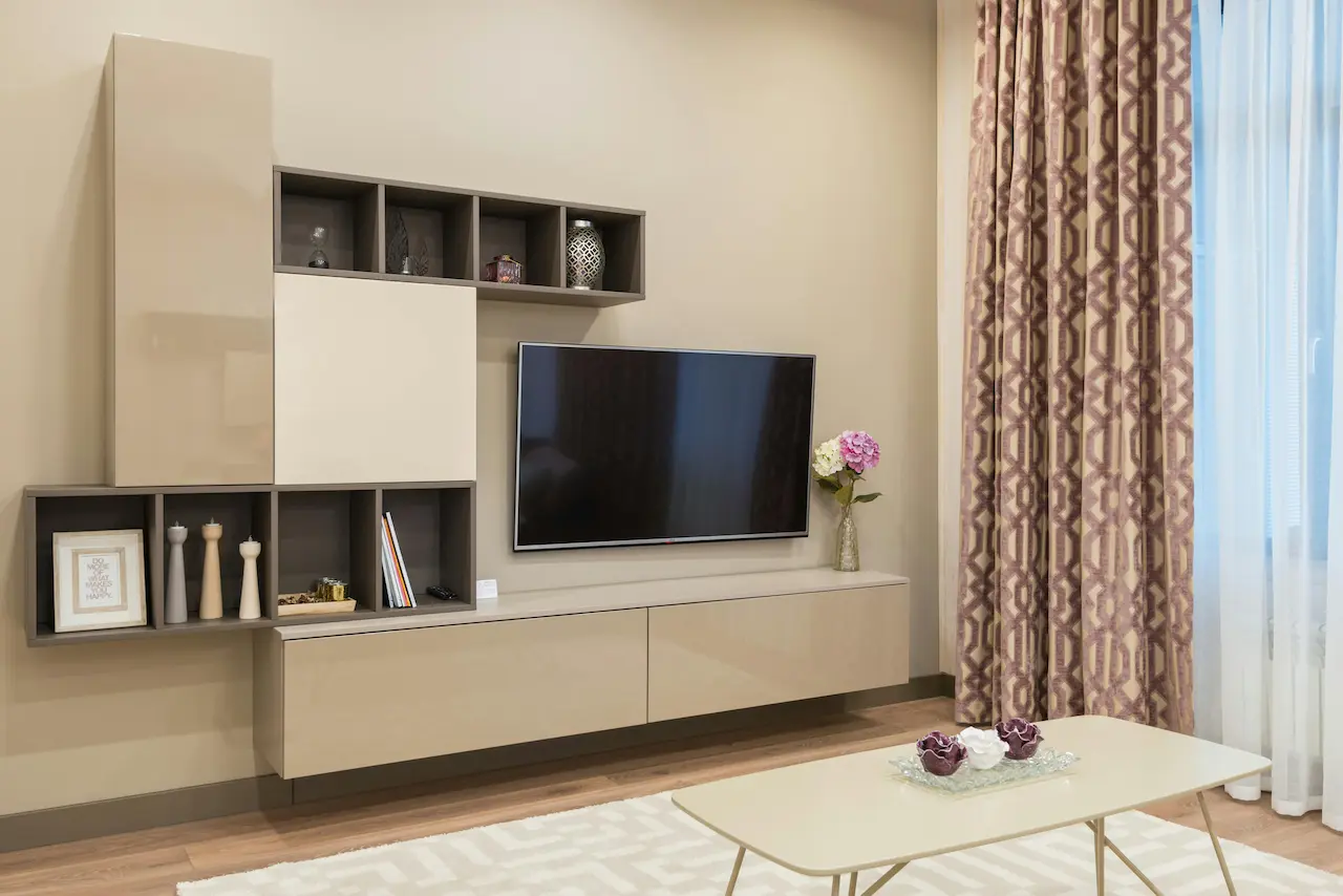 Cozy living room with modern furniture and TV set, featuring low-density fiberboard elements.