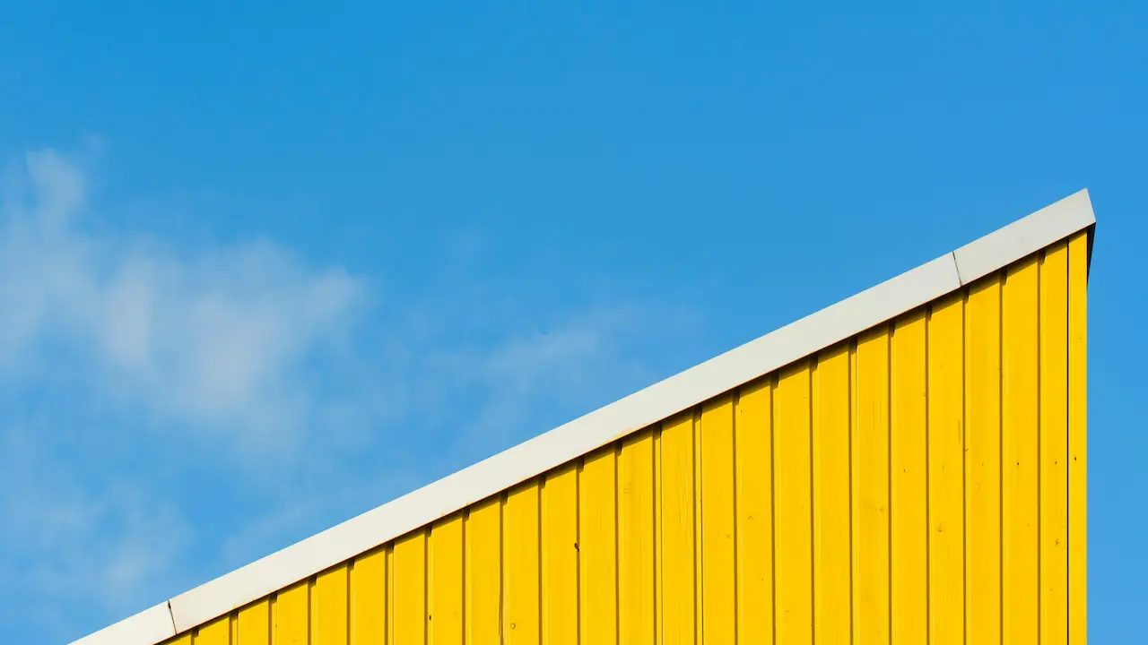 Compact modern house with a small yellow shed roof design.