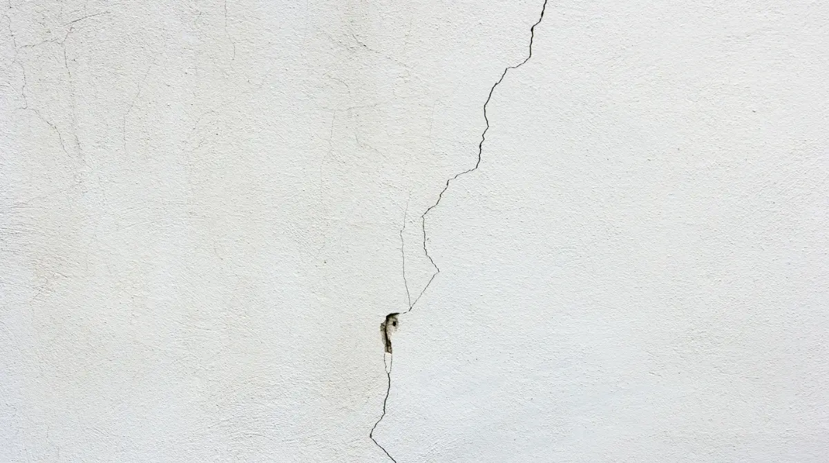 small, normal crack on a wall, typical of minor settling or aging