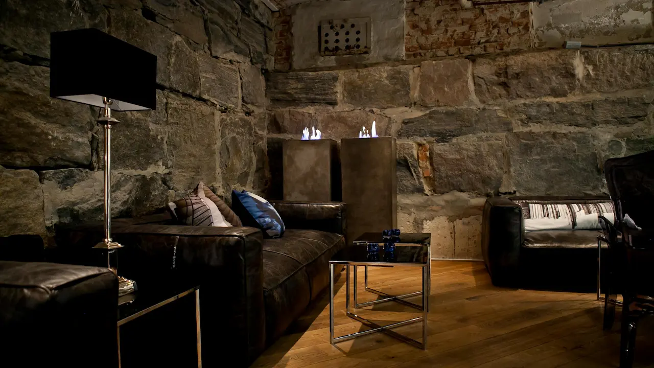 Rustic industrial living room with a brown leather sofa near the wall.