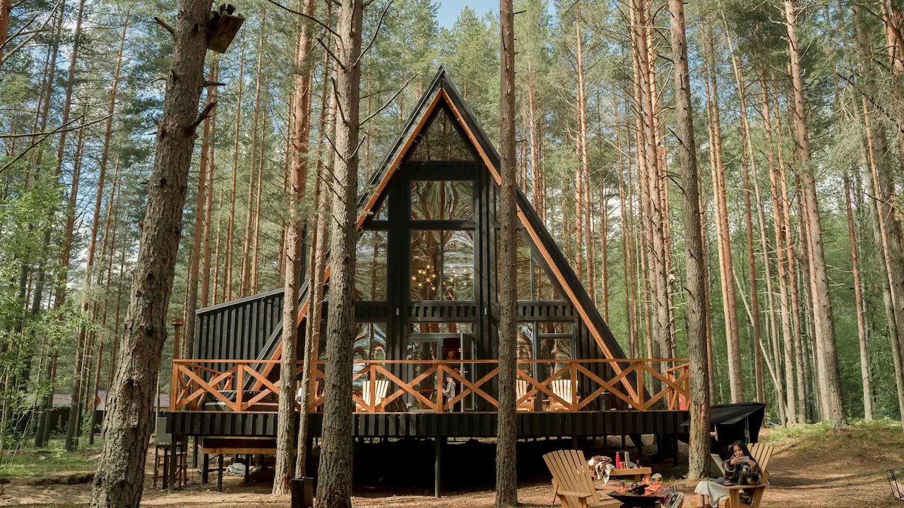 Tiny wooden house with a glass wall.