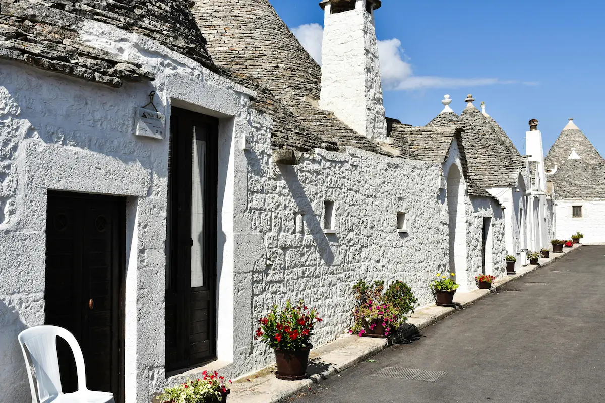 Traditional Trulli houses in Alberobello, Apulia, Italy, showcasing unique conical roofs and local materials.