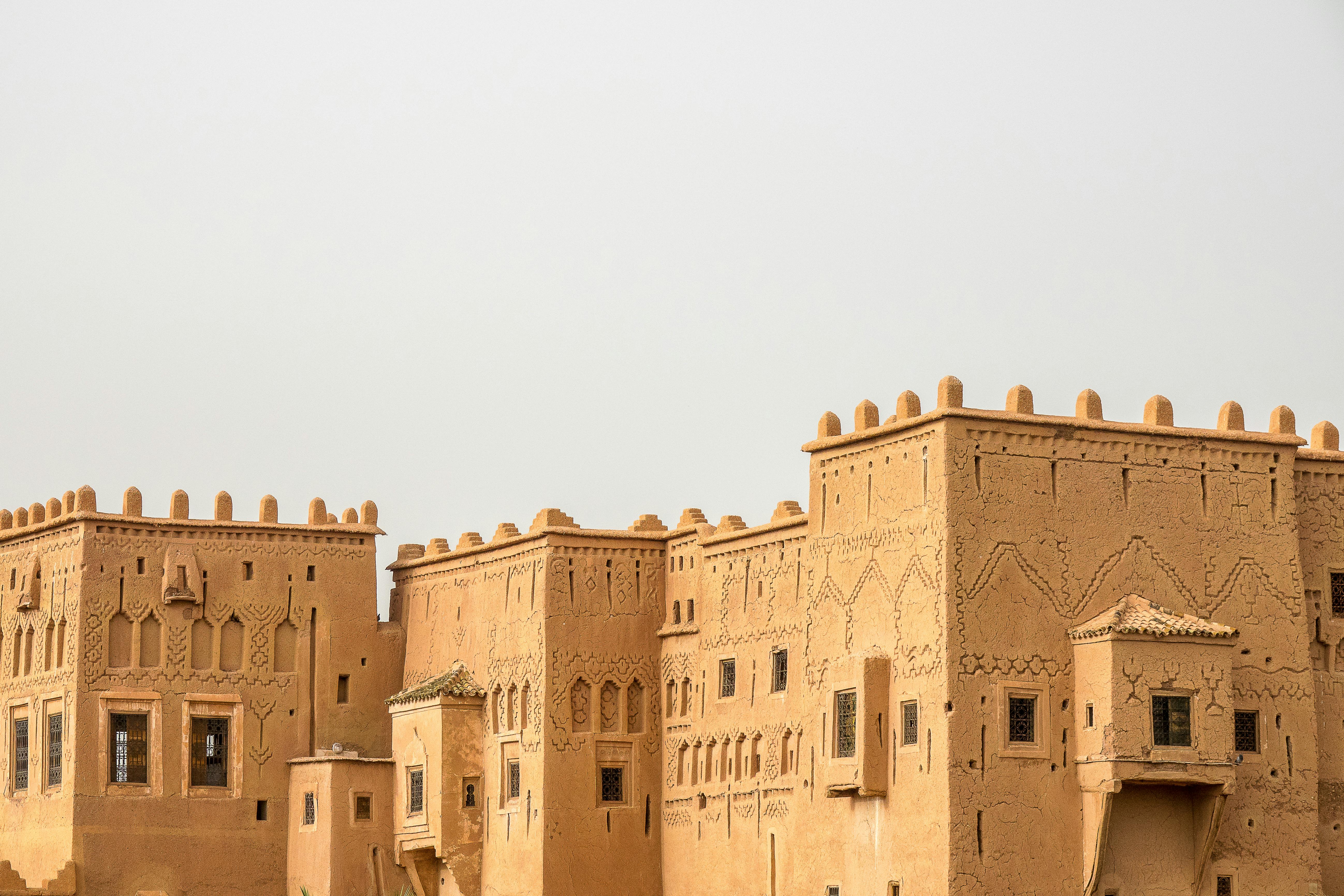 Ancient historical buildings with towers, constructed using vernacular clay materials.