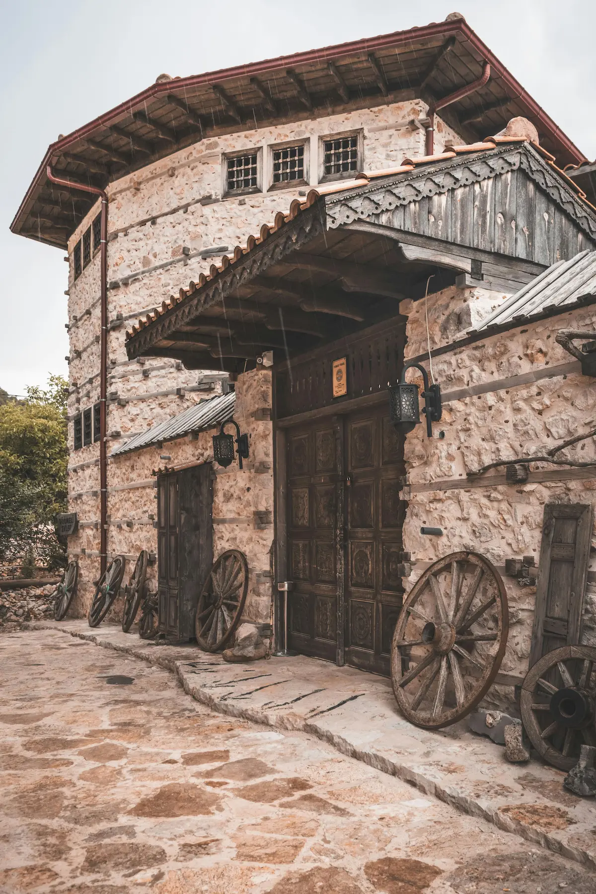 A rustic stone house constructed with vernacular materials, blending tradition and local craftsmanship.