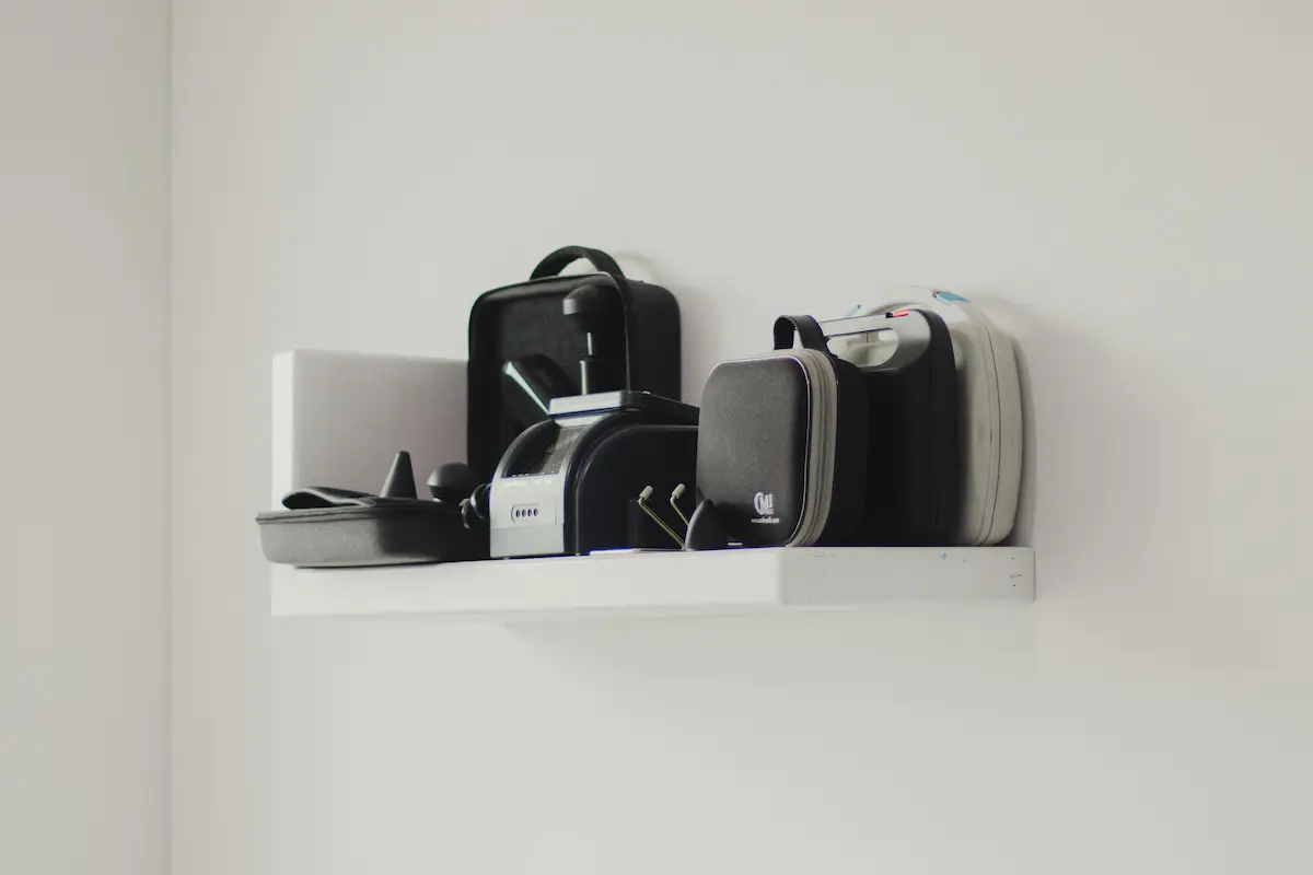 A white shelf mounted on the living room wall, offering sleek storage without cluttering the space for a minimalist look.