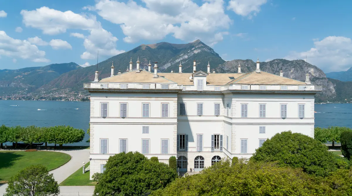 white mansion beside a river in italy
