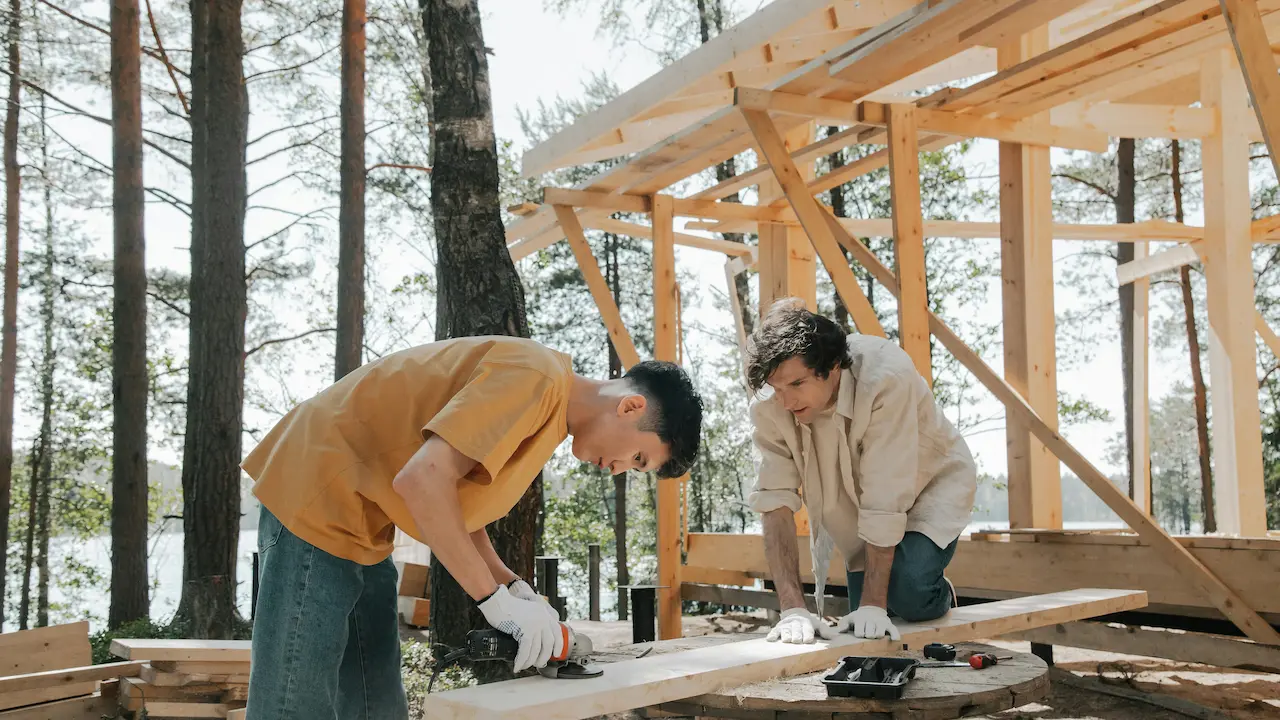workers building a post-frame structure during construction