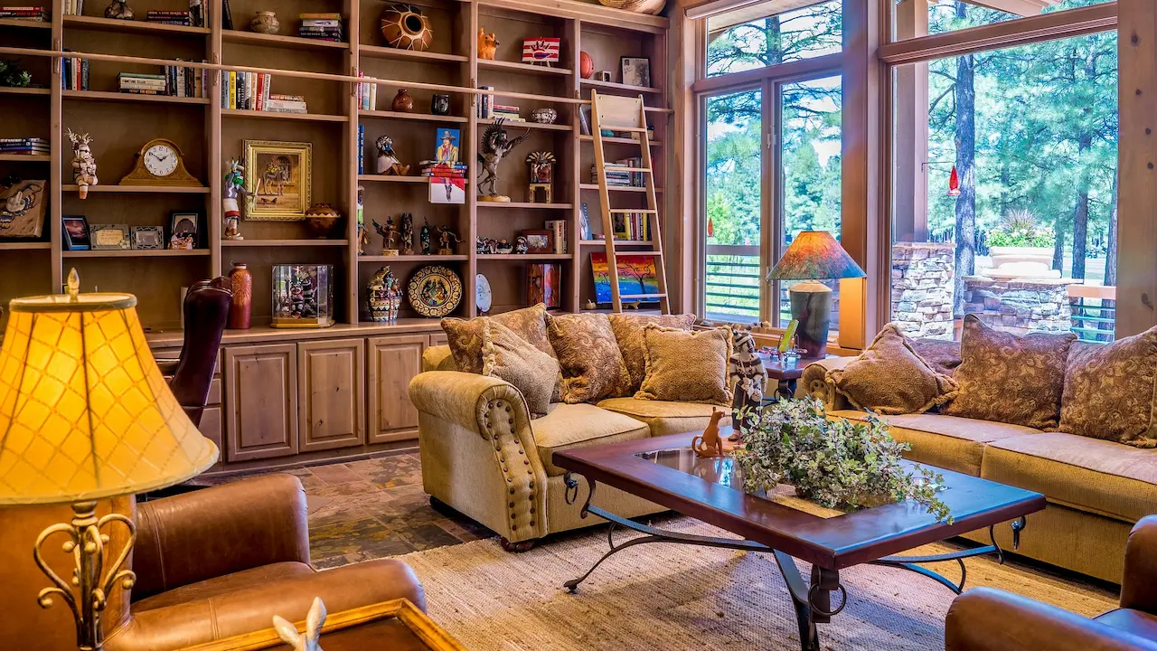 90s living room with oversized sectional sofa, wood-paneled walls, and a massive entertainment center