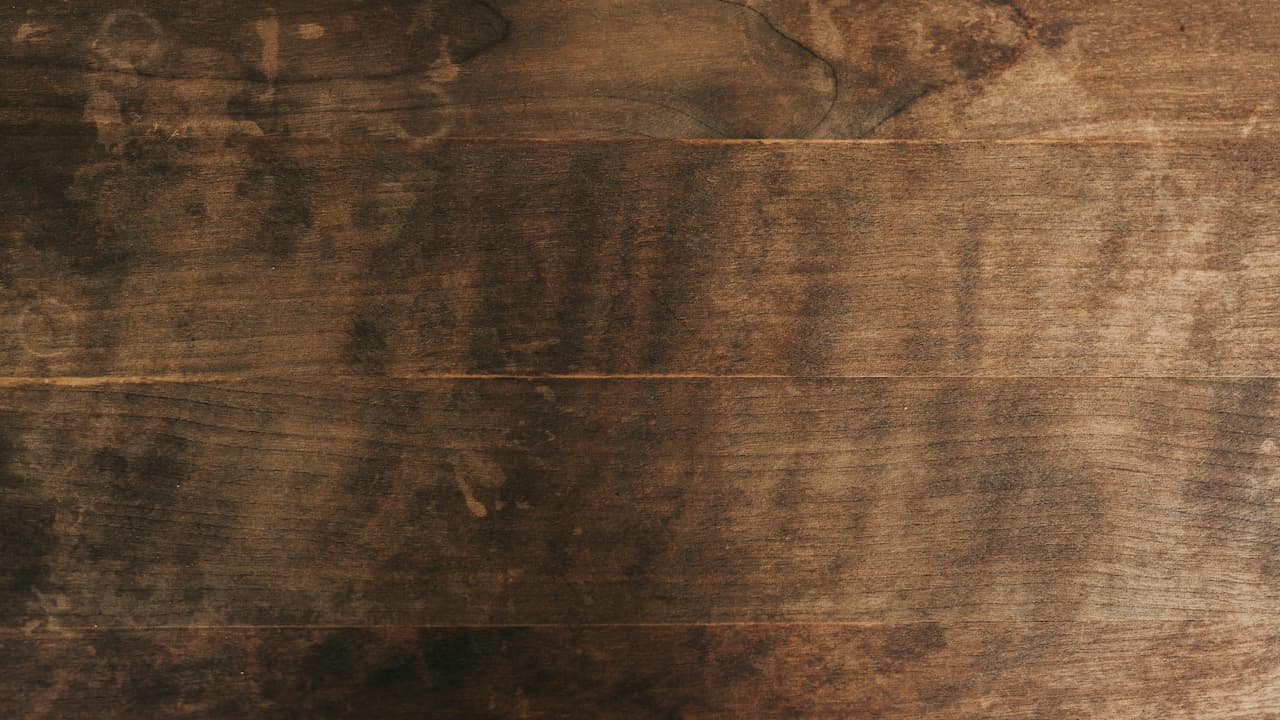 Close-up of a wood parquet floor with intricate patterns, showcasing natural grain and polished finish.