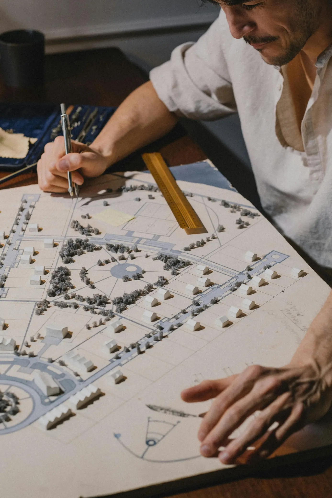 An architect focused on creating and refining an architectural model, carefully shaping details and design elements.