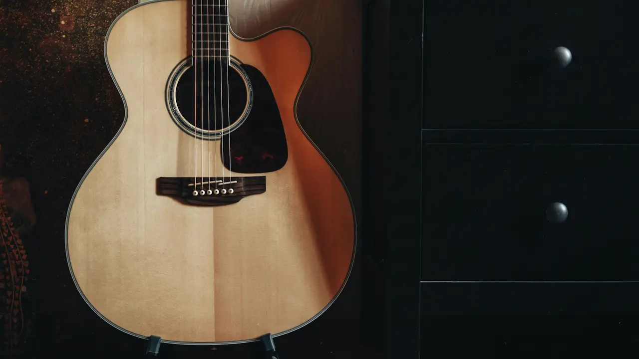 A mahogany acoustic guitar with a rich wood grain, smooth finish, and warm tonal quality.