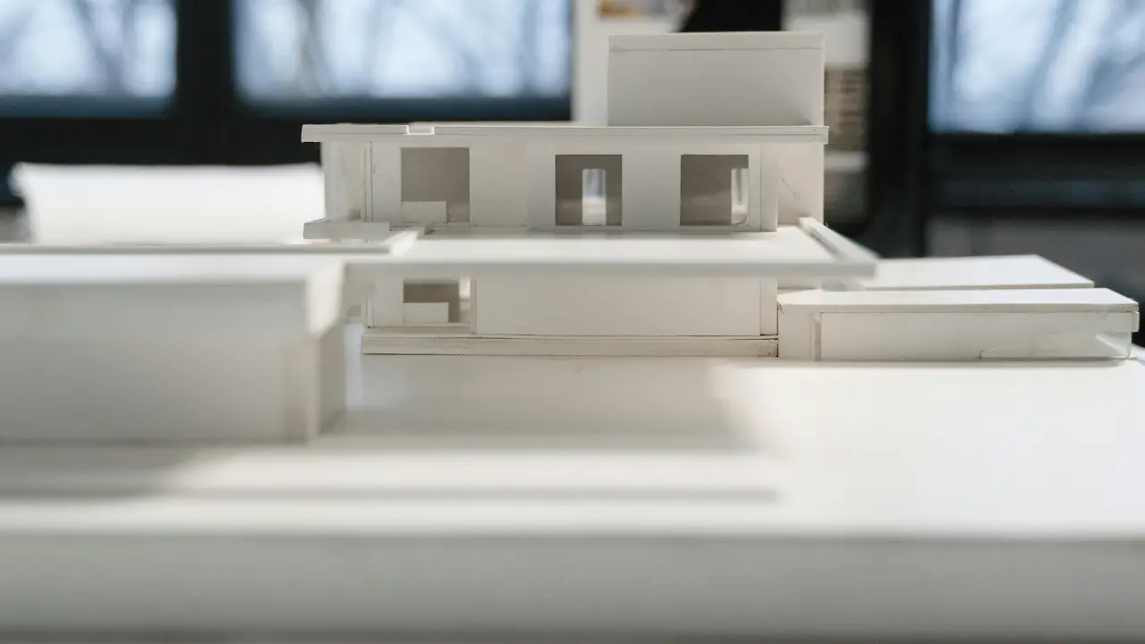 A miniature house model made of cardboard, showcasing design concepts and structural planning.