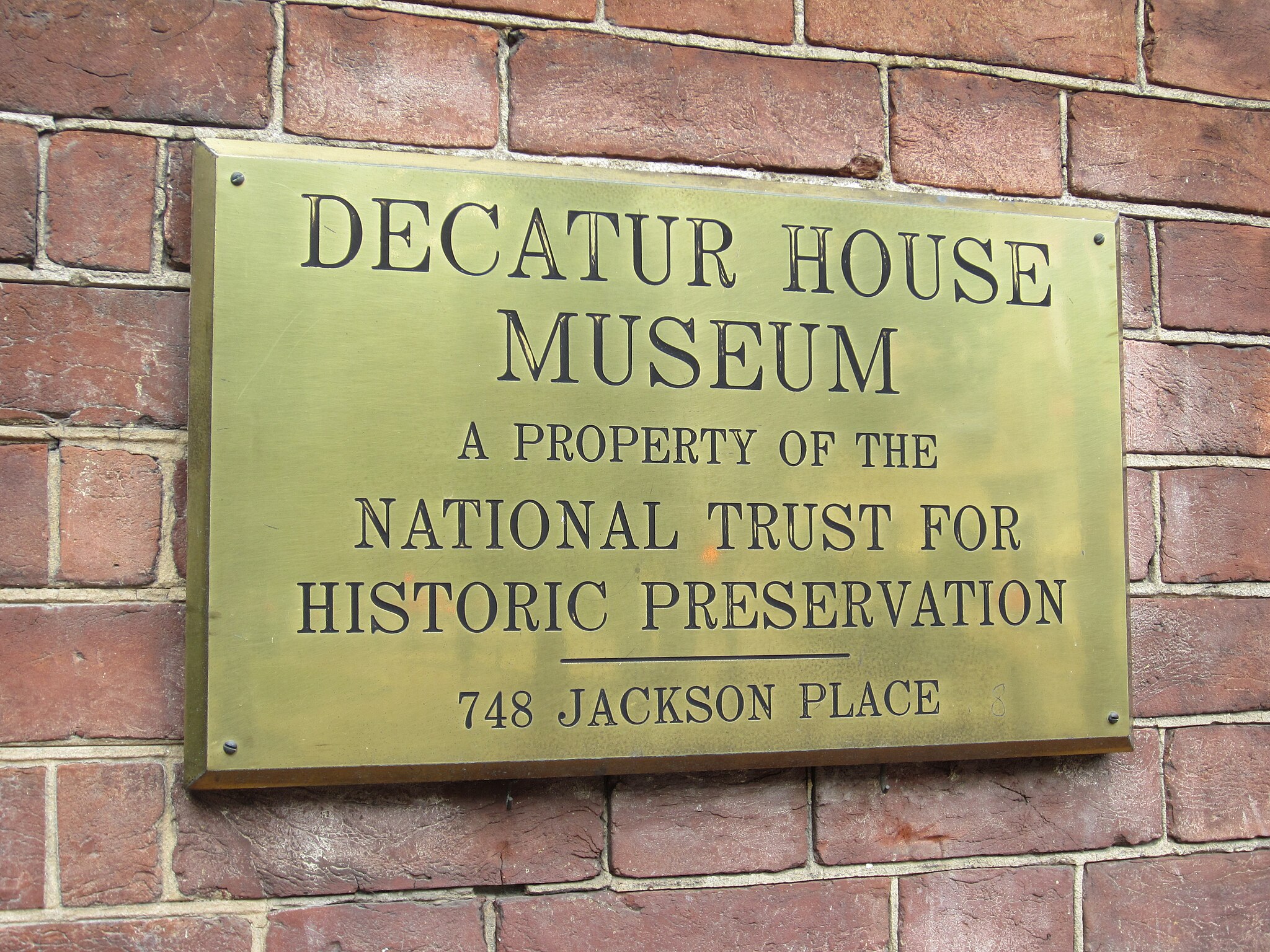 A historical plaque at Decatur House Museum, detailing its significance and history.