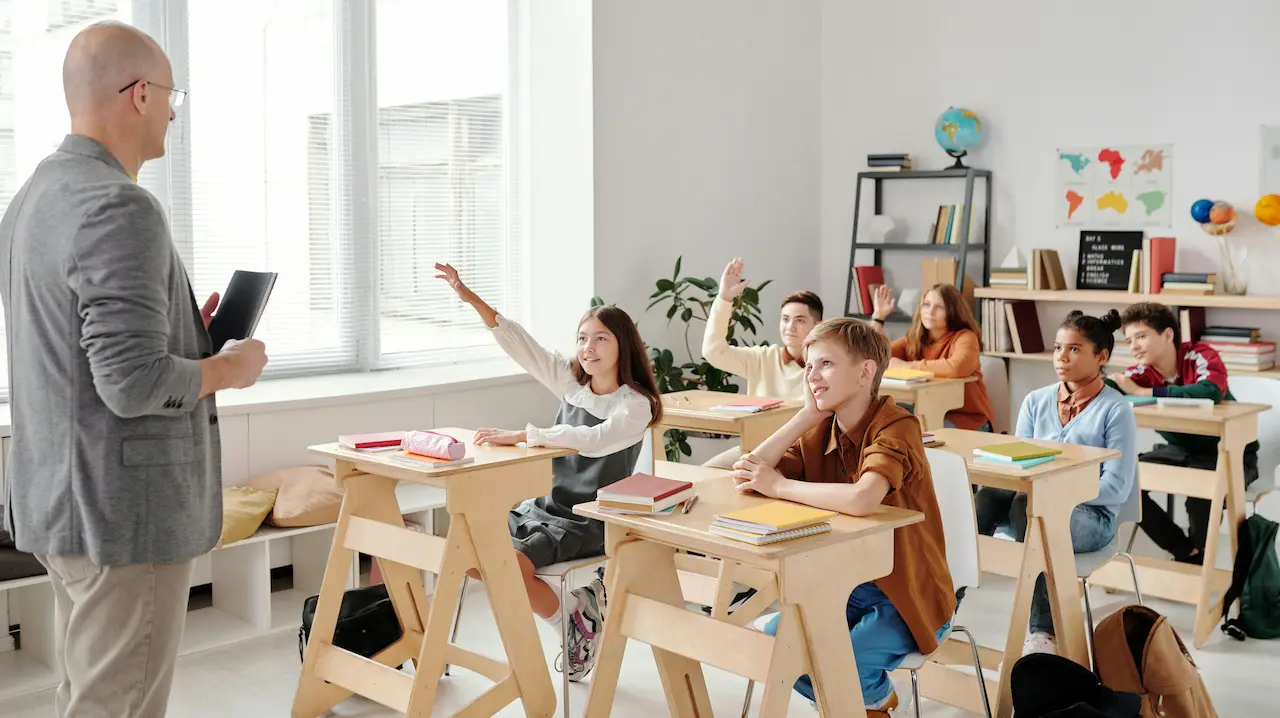 An elementary school teacher introducing architecture concepts to students, fostering creativity and learning.