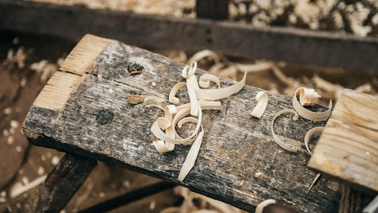 Raw wood piece being processed into engineered wood for construction.