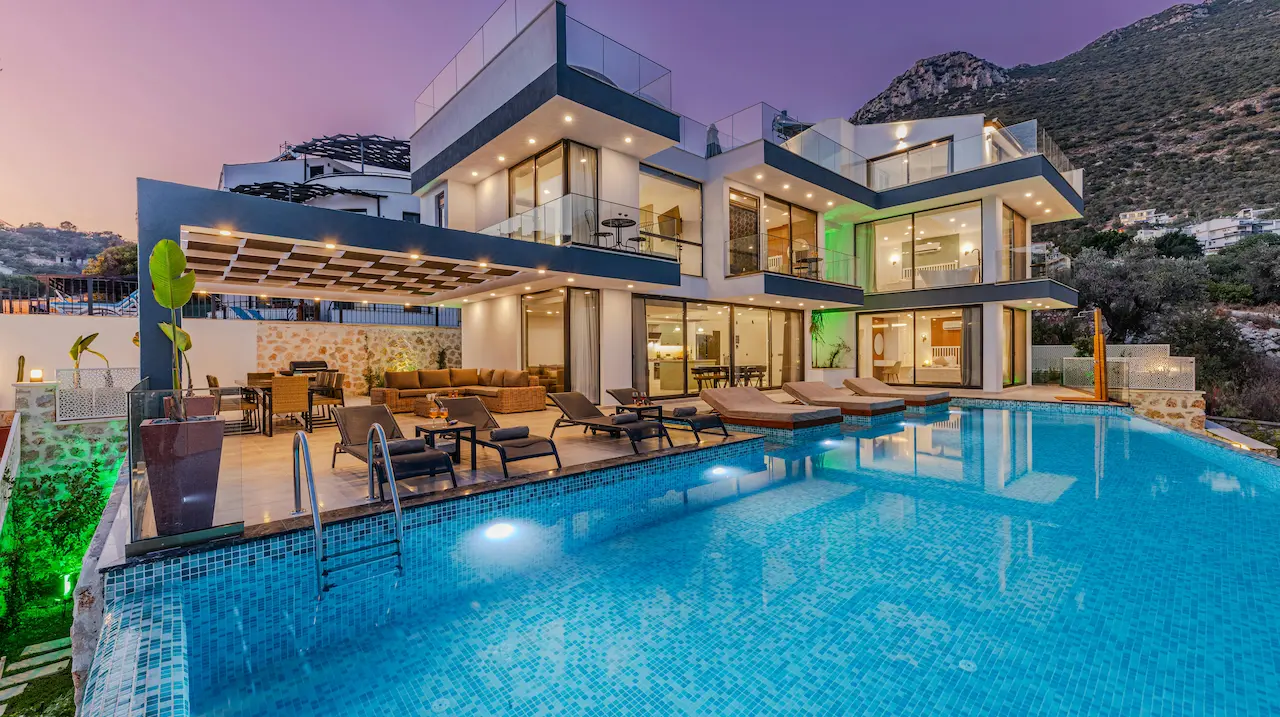 A luxury large house with a pool, offering a stunning view of the mountains.