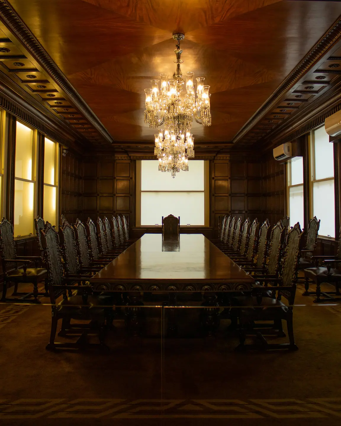 Mahogany table and chairs set in a luxury wooden room, showcasing fine craftsmanship and elegance.