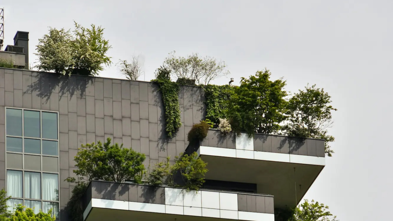 A modern building with balcony gardens, integrating plants for natural cooling, aesthetics, and sustainability.