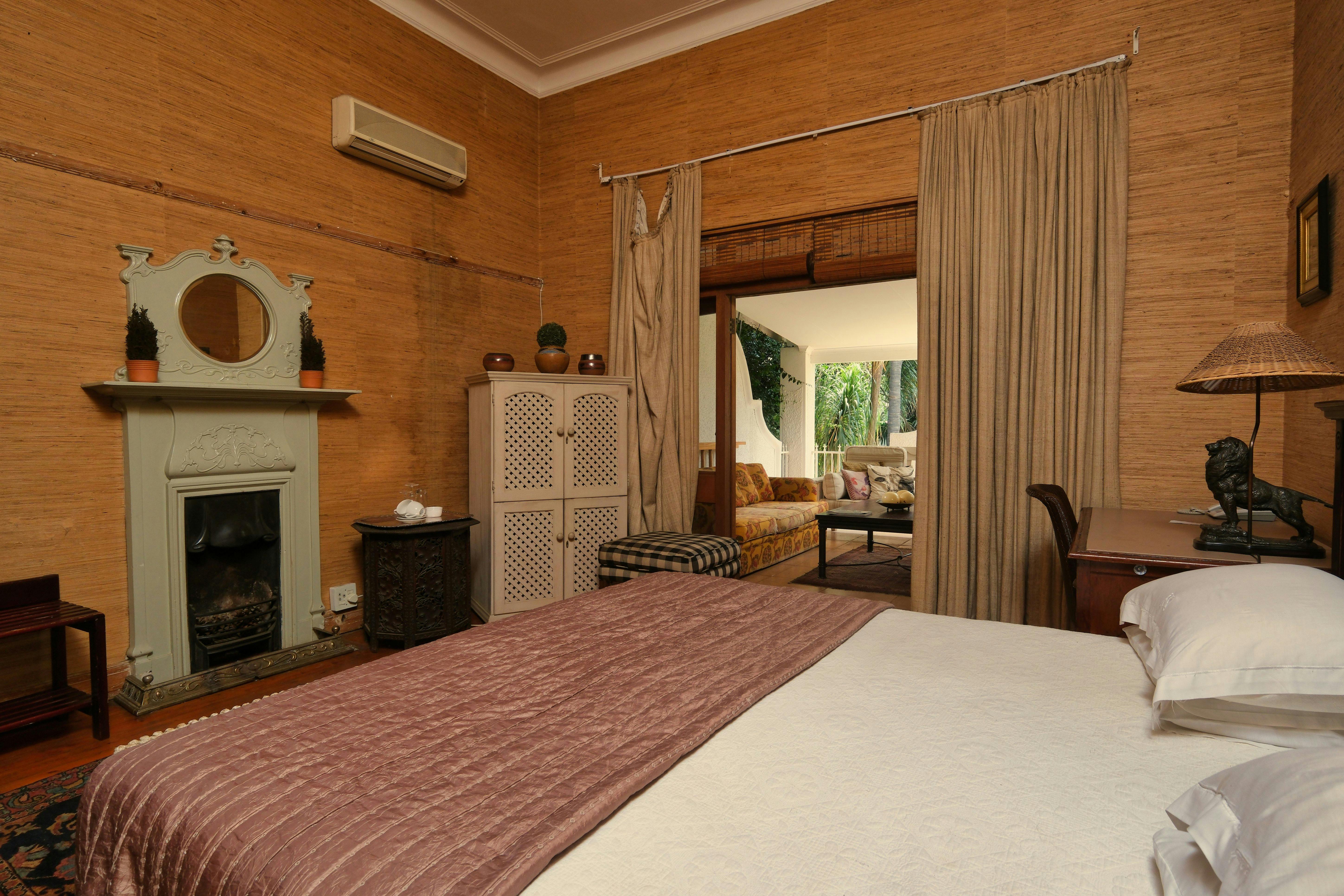 Beautiful classic 1940s bedroom with a fireplace and vintage decor.